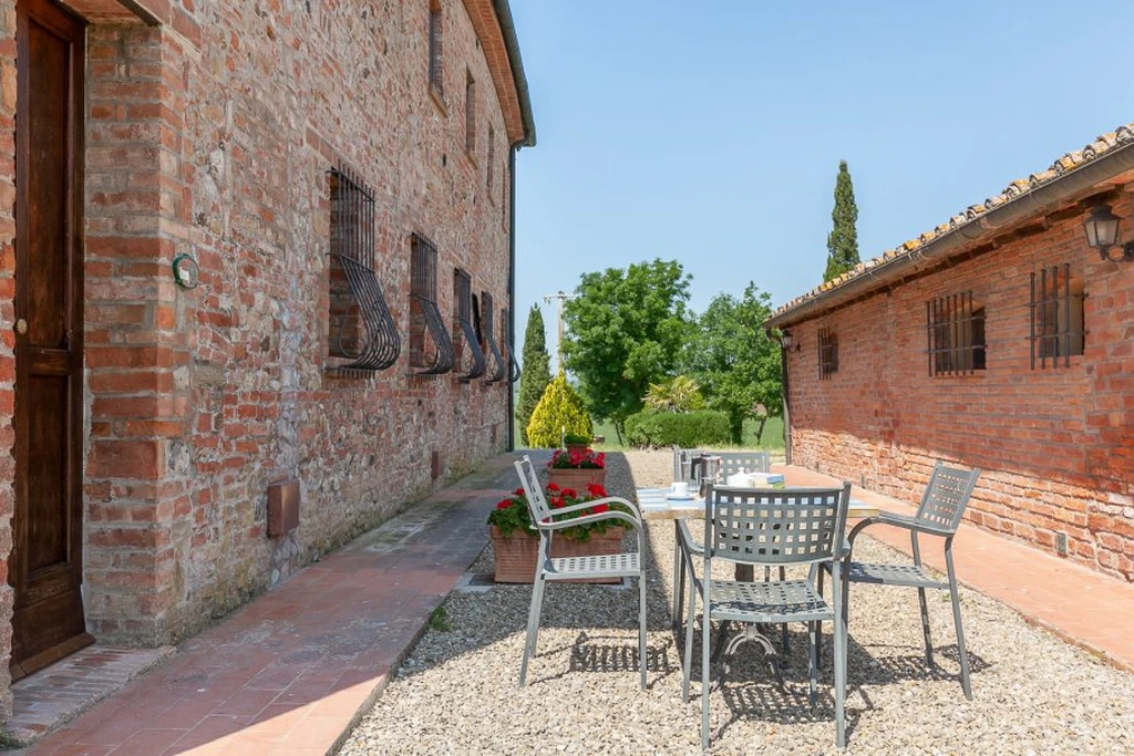 Toscane il gattero edera buitentafel bij de bakstenen gevel